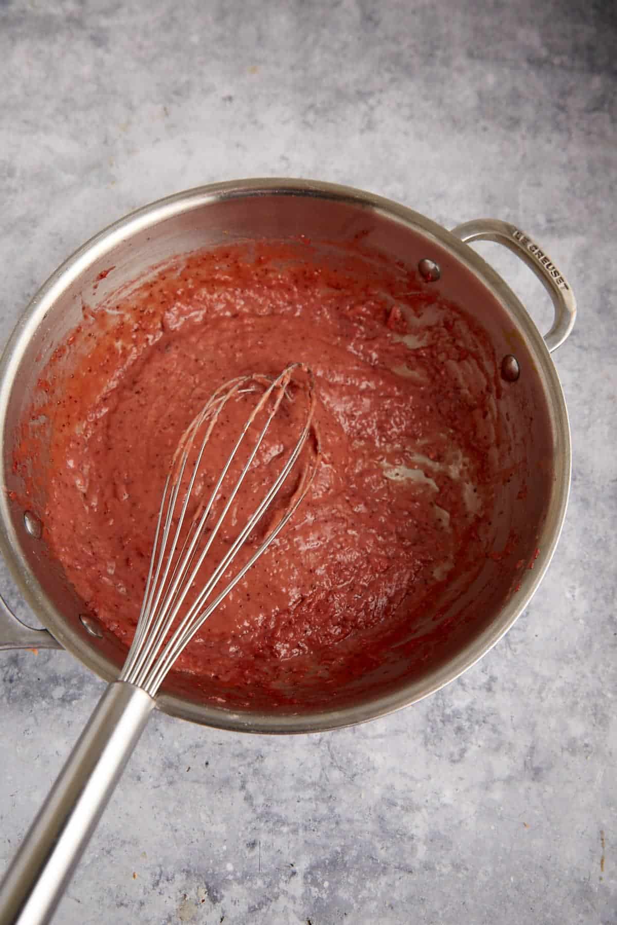Cooked strawberry filling in a saucepan.
