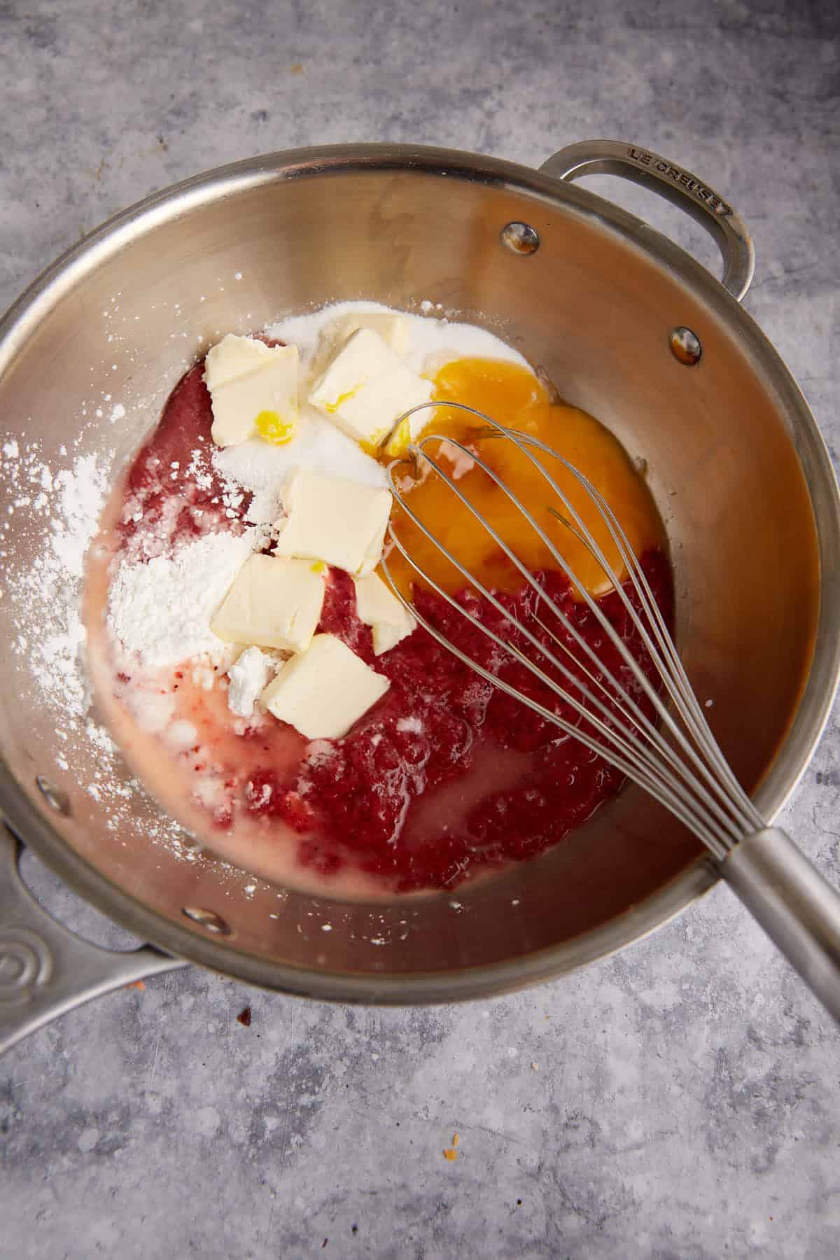 The ingredients for the filling in a saucepan with a whisk.