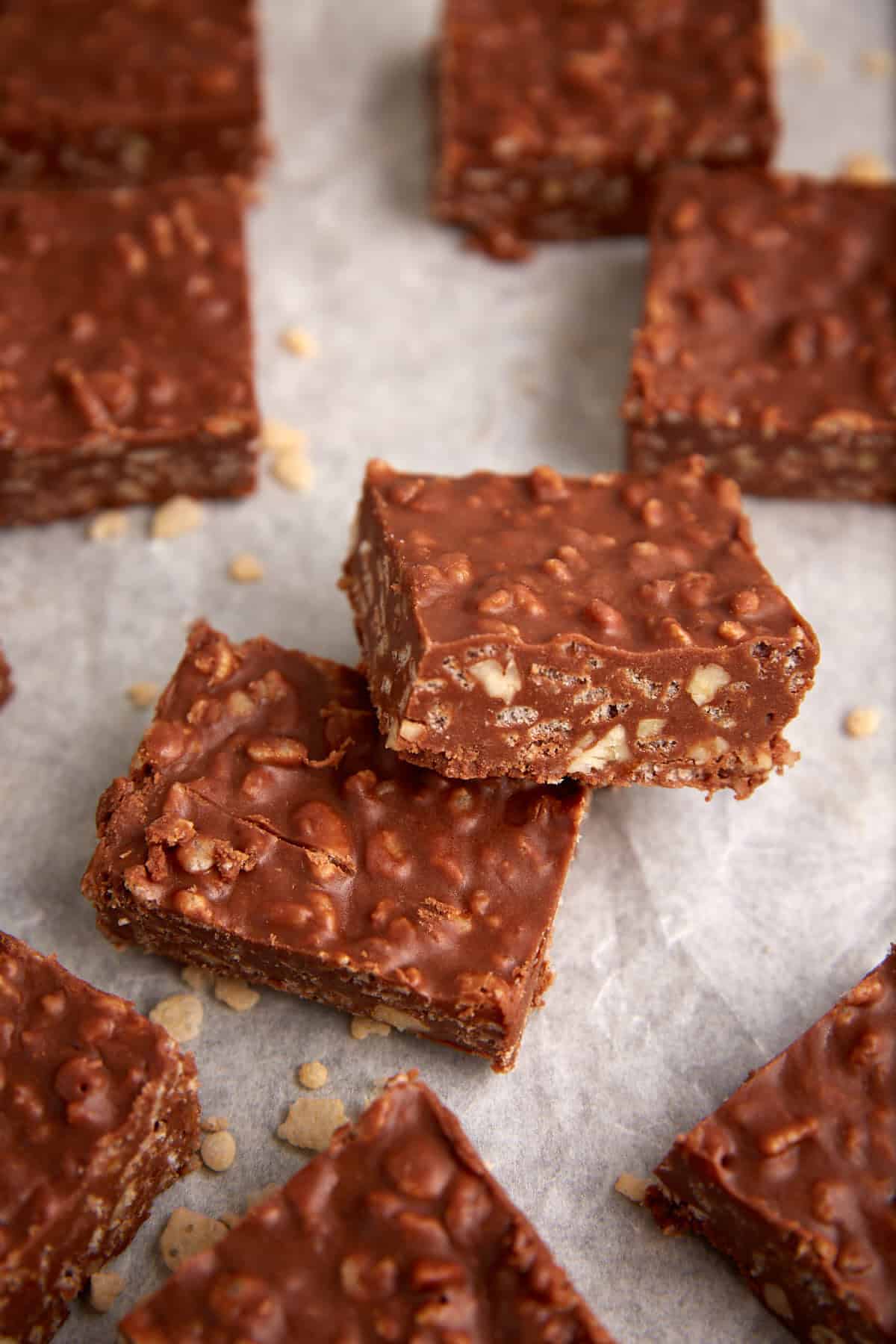A batch of chocolate rice krispie squares on parchment paper.