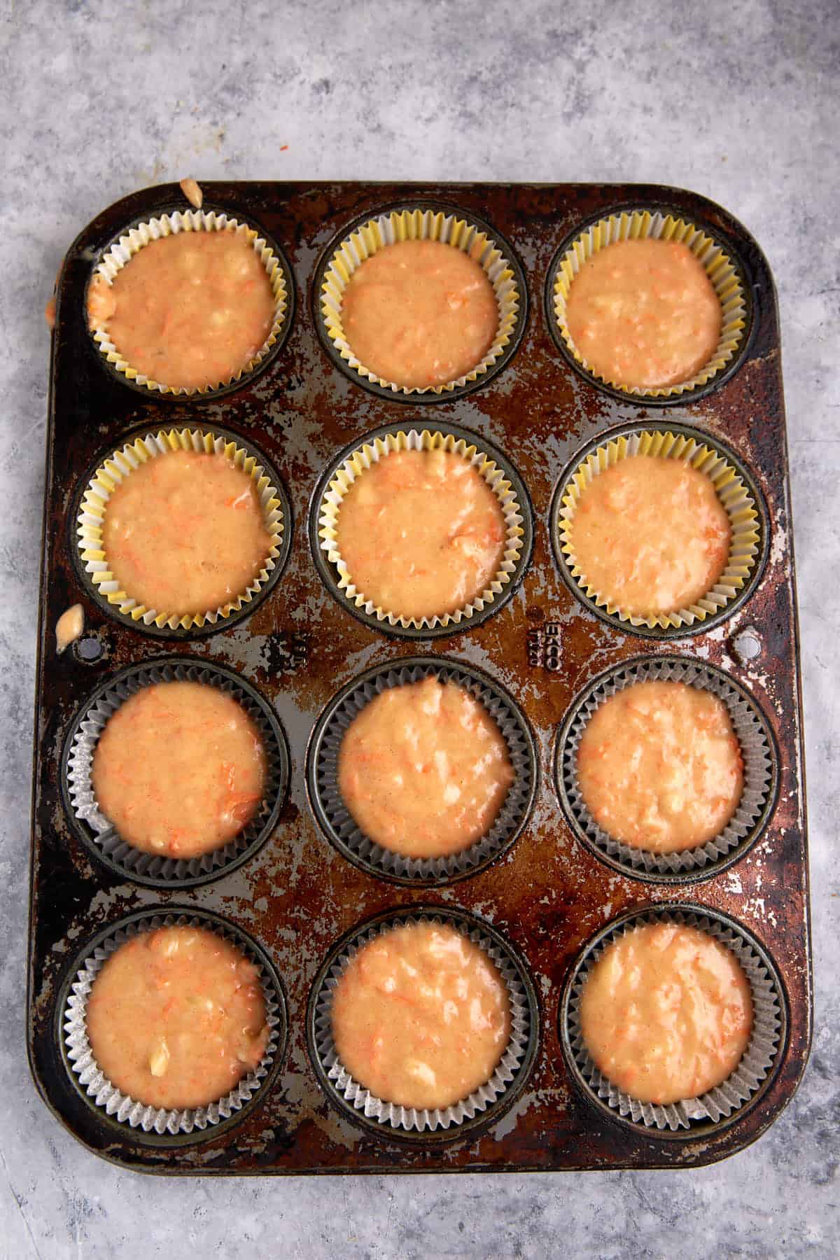 carrot cake cupcake batter in a muffin pan.
