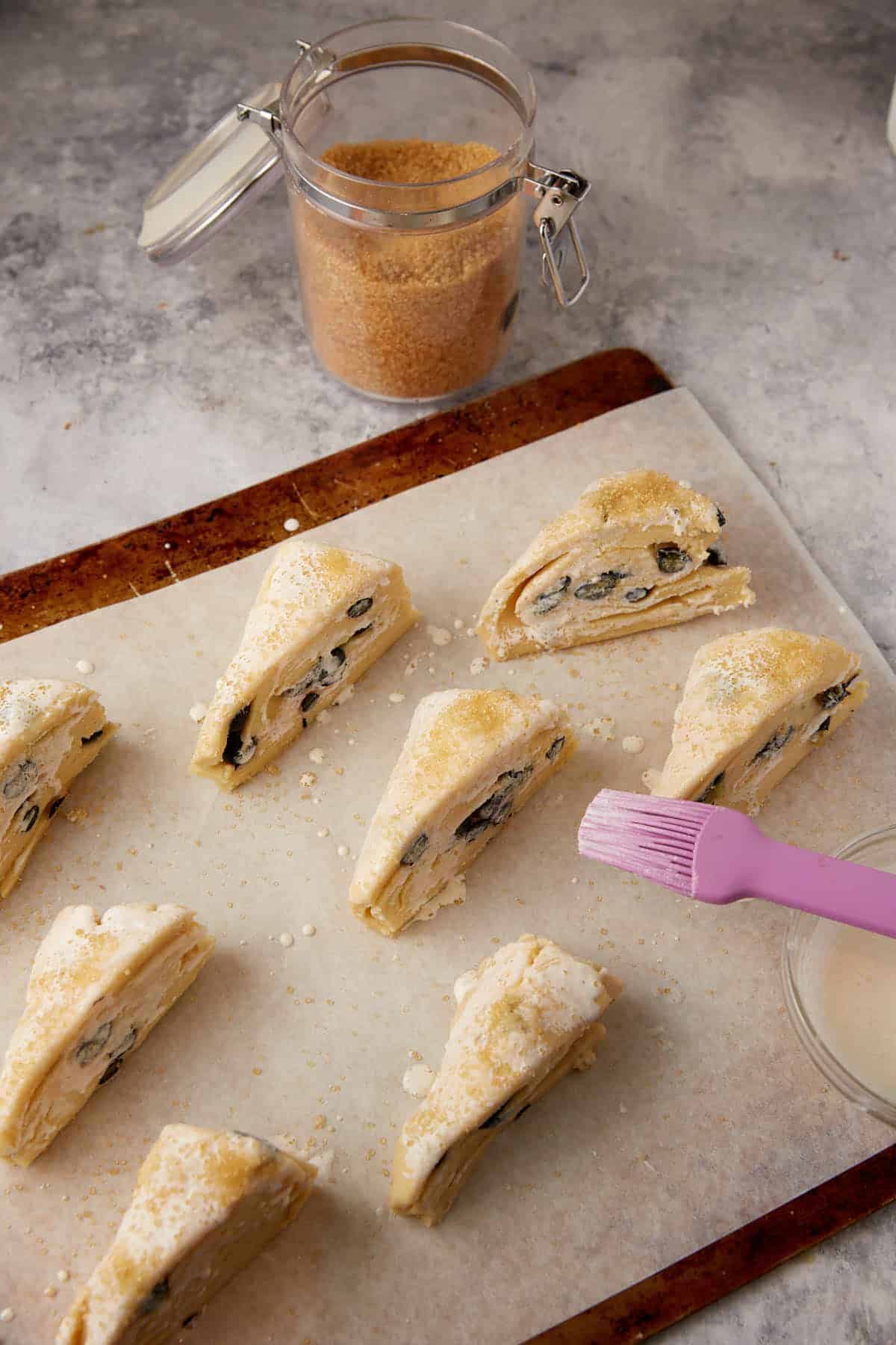 Triangles of dough brushed with cream.