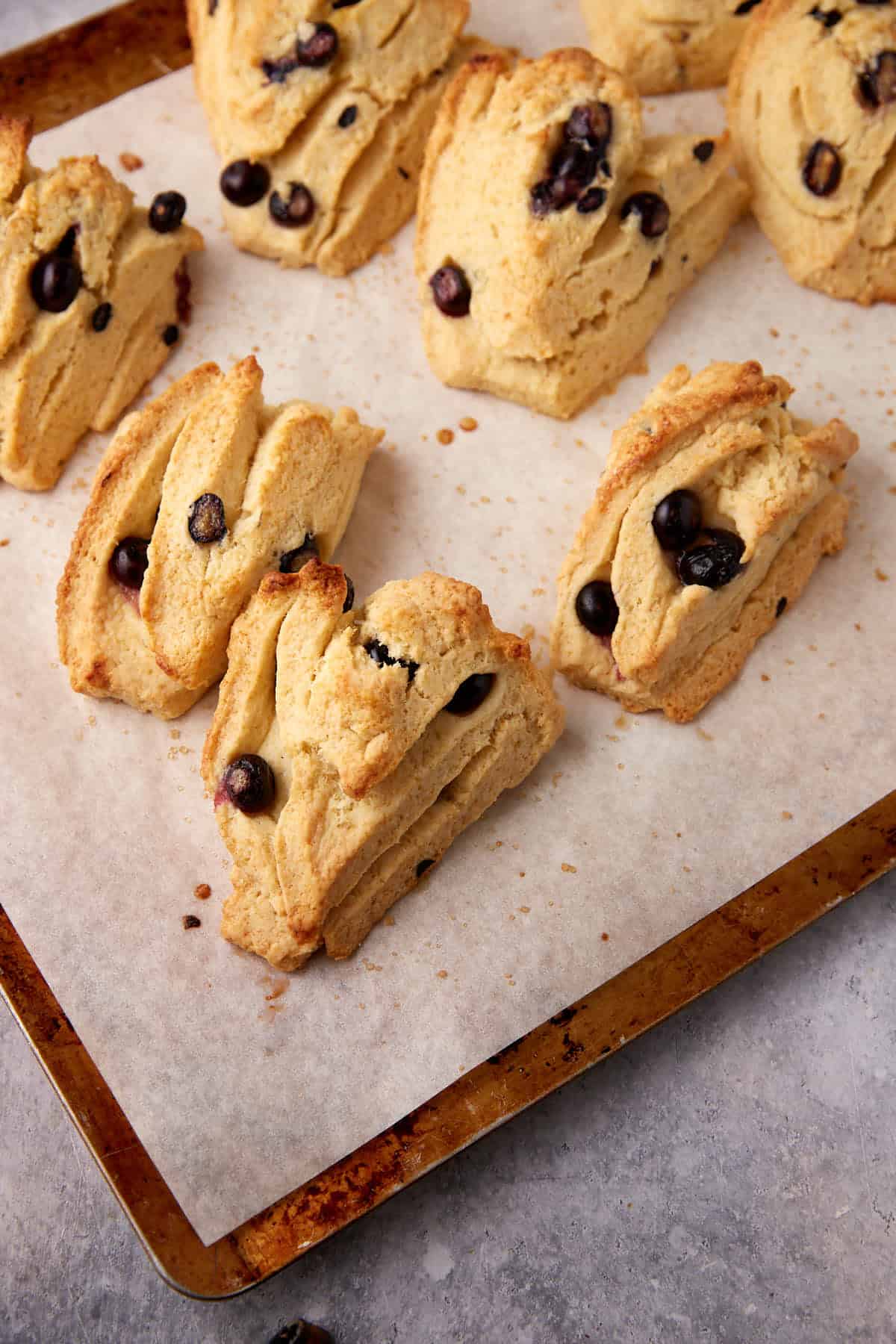 baked blueberry scones on a baking sheet.