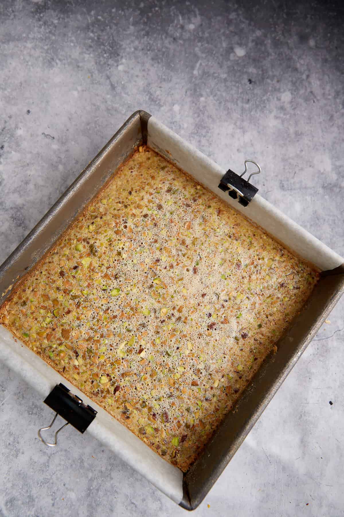 Baked lemon pistachio bars in a pan.