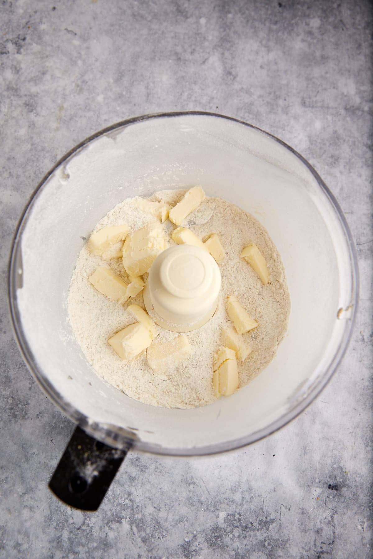 Butter being cut into shortbread dough.