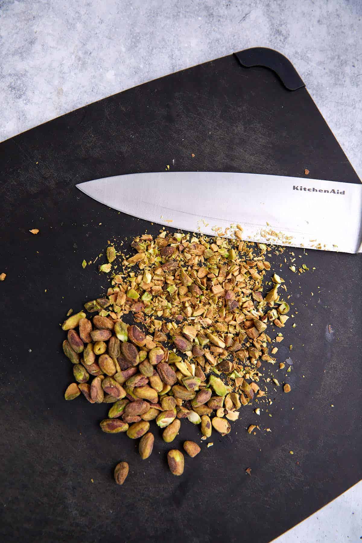 Chopped pistachios on a cutting board.