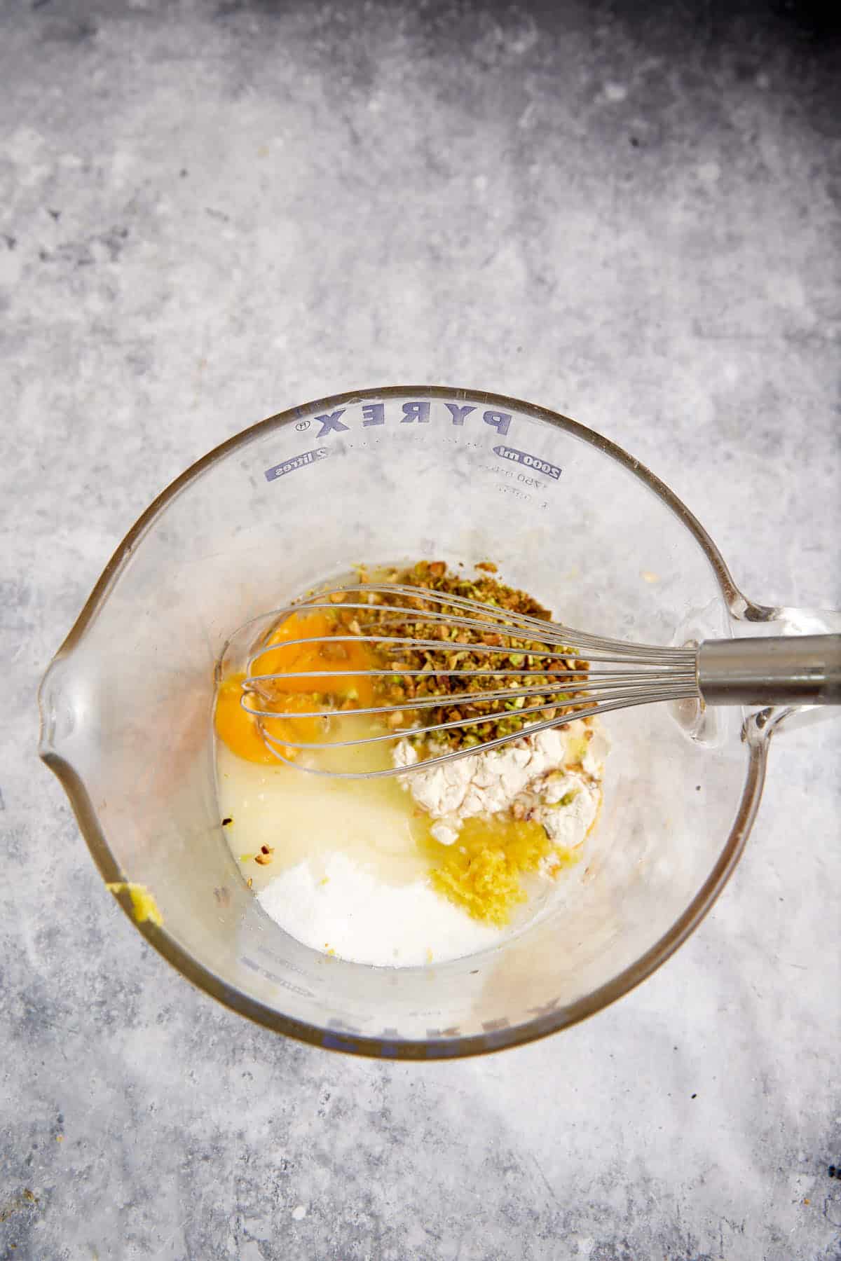 The filling for lemon bars in a mixing bowl.