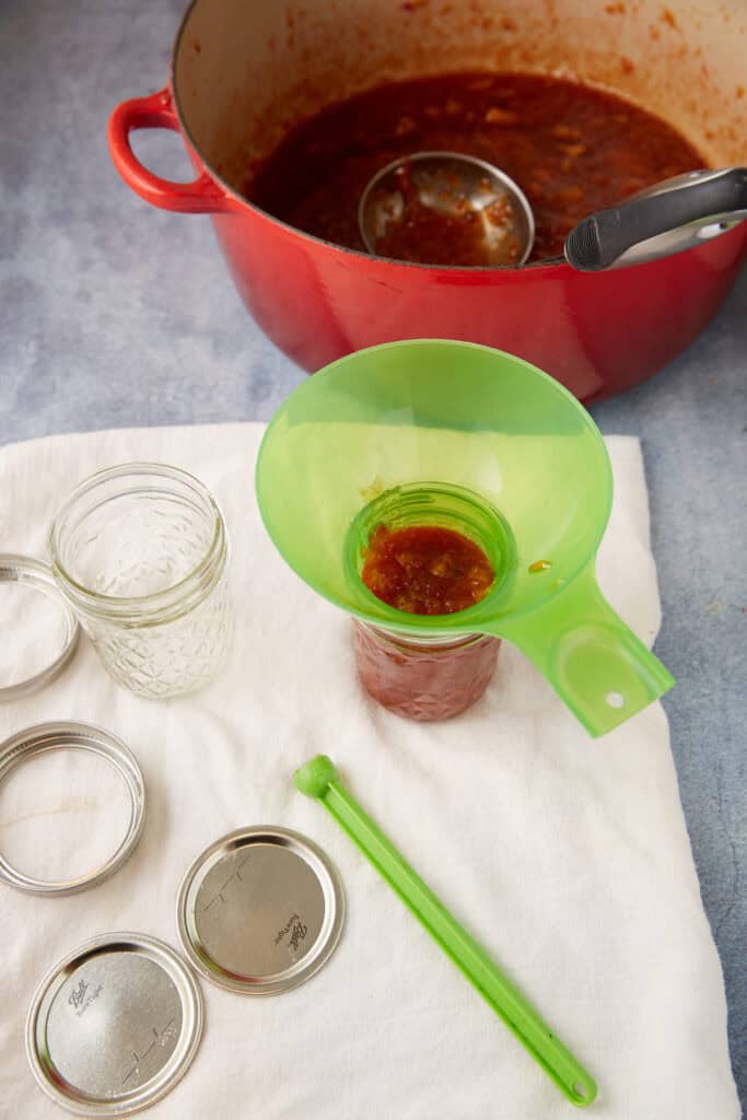 Jam being poured into a jar.