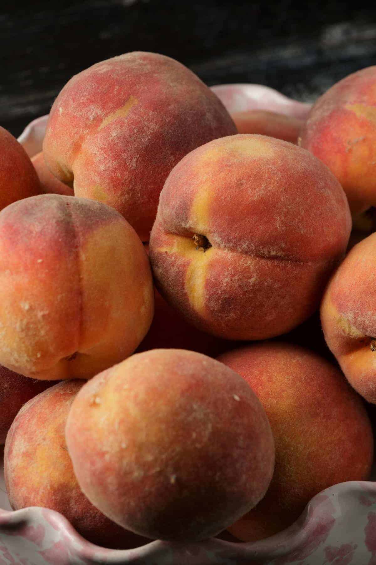 A basket of fresh picked peaches.