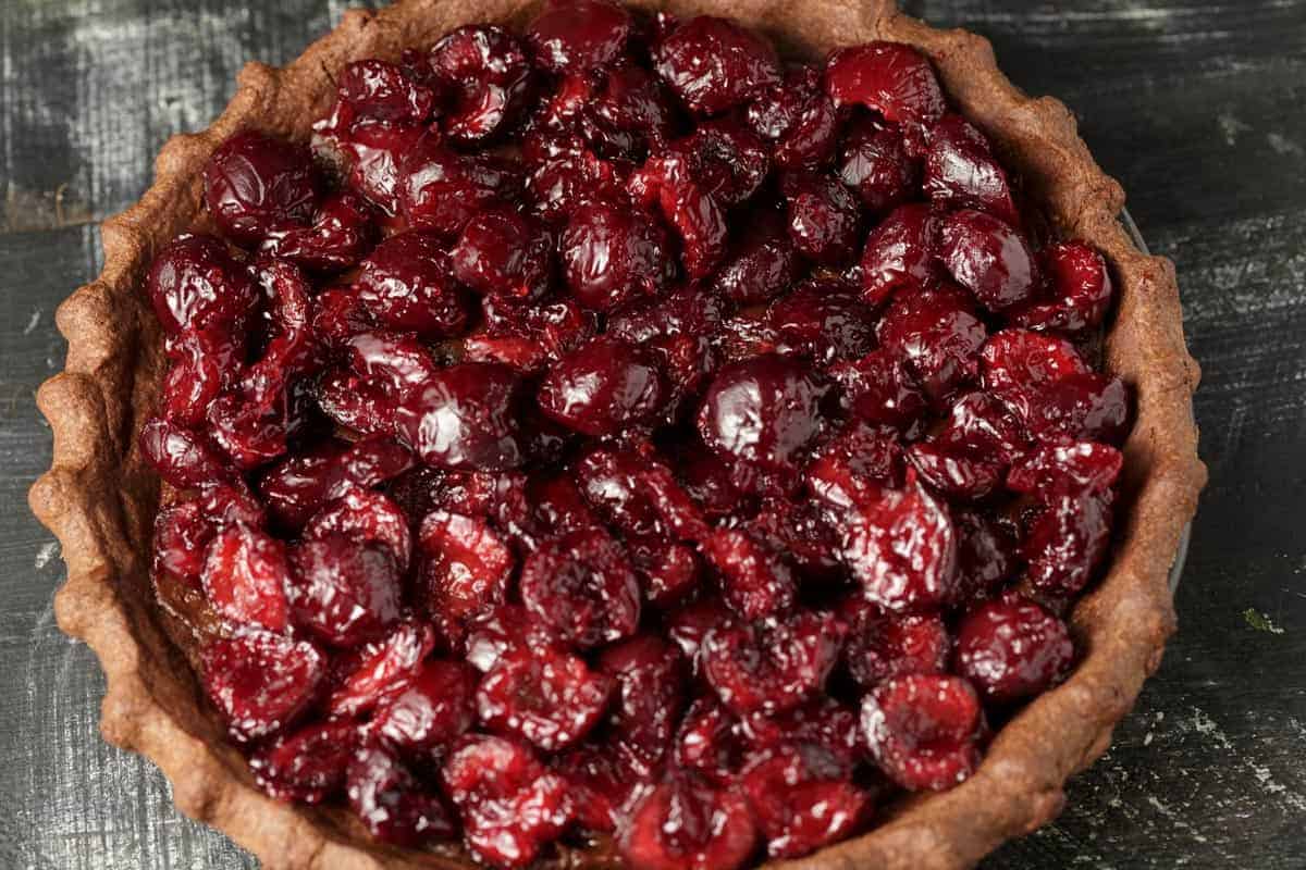 Cooked cherries added to a pie.
