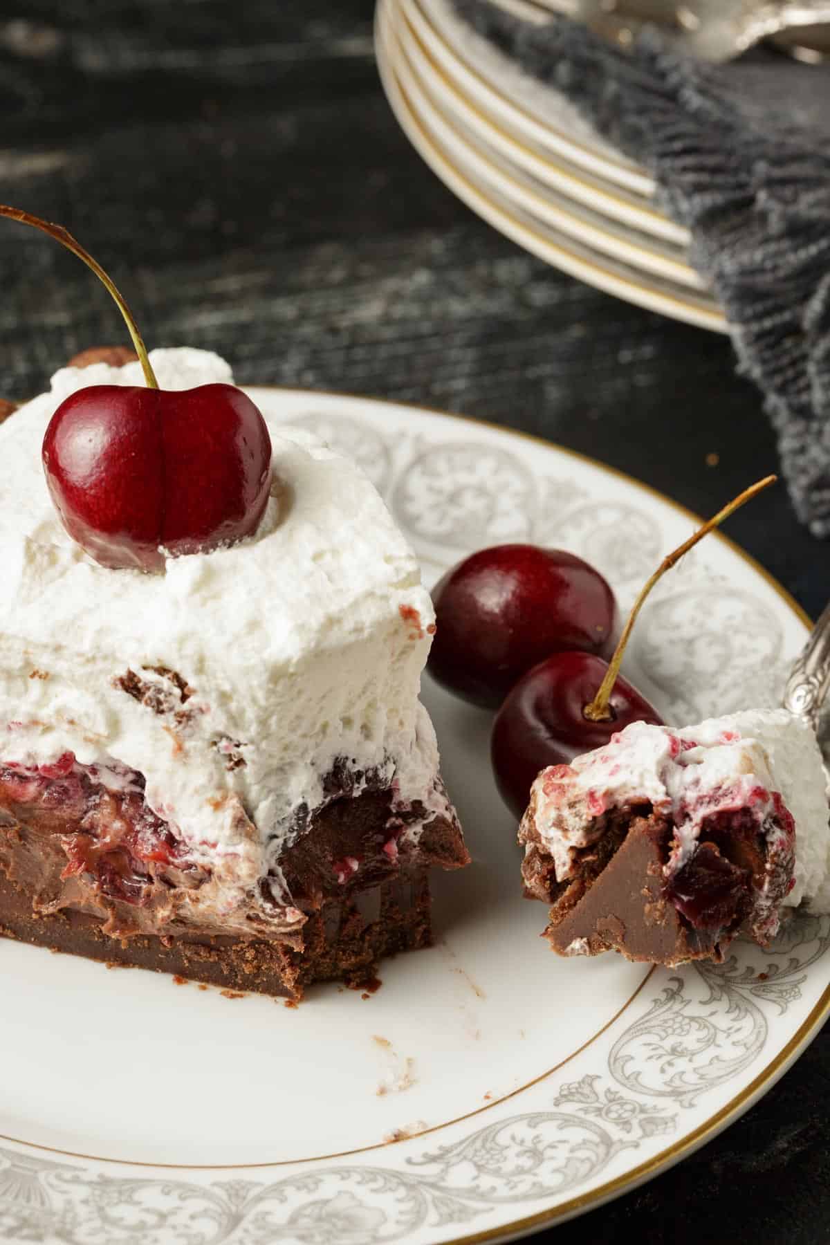 A bite of chocolate cherry pie on a fork.