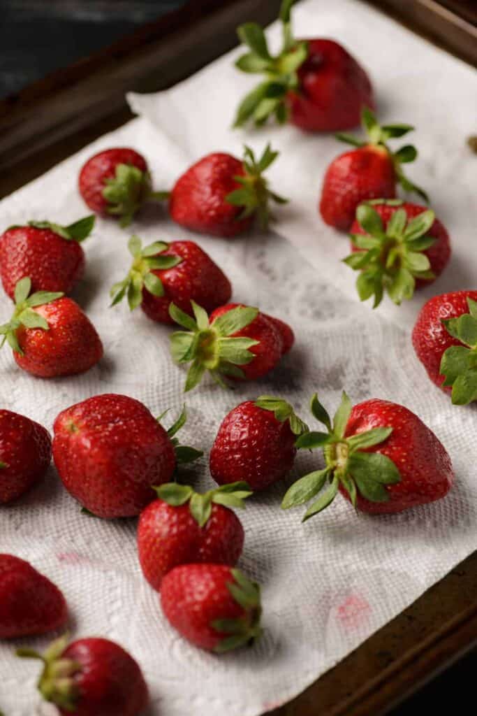 Strawberries drying on a paper towel.