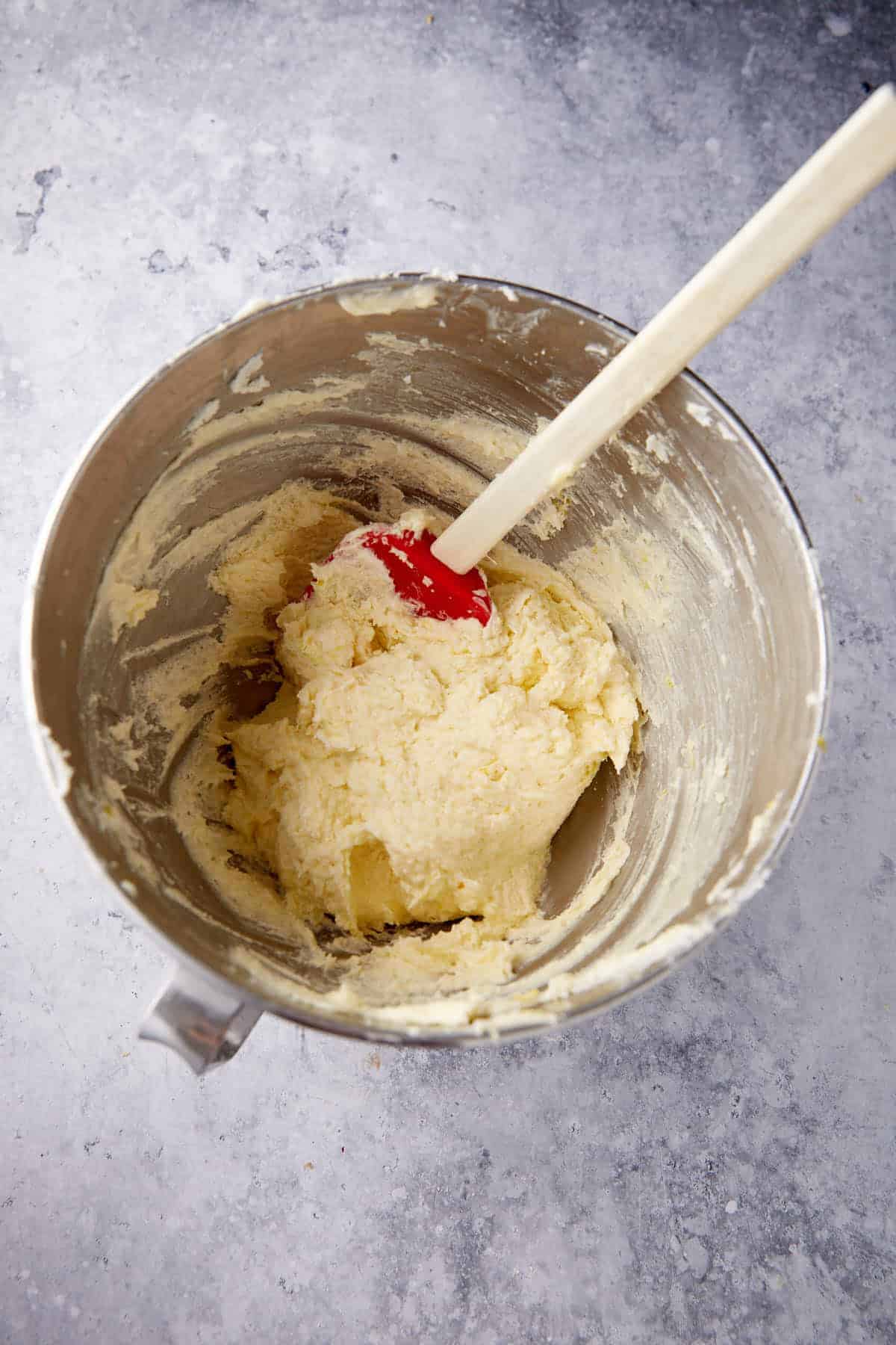 eggs added to a cake batter in a bowl. 