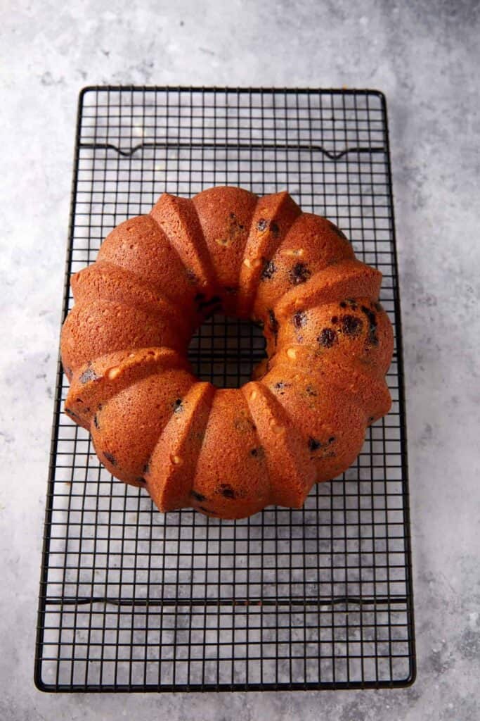 A baked bundt cake on a wire rack.