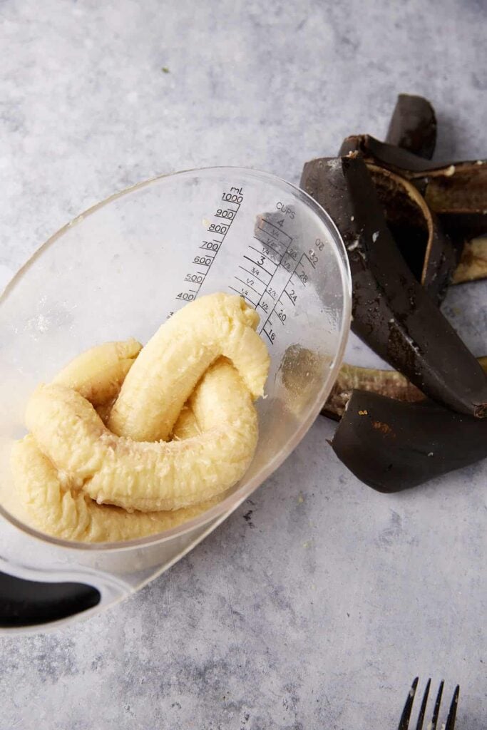 Ripe bananas in a measuring cup.