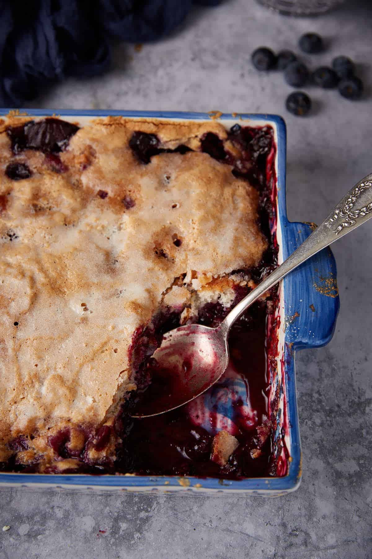 A casserole dish of blueberry self saucing pudding.