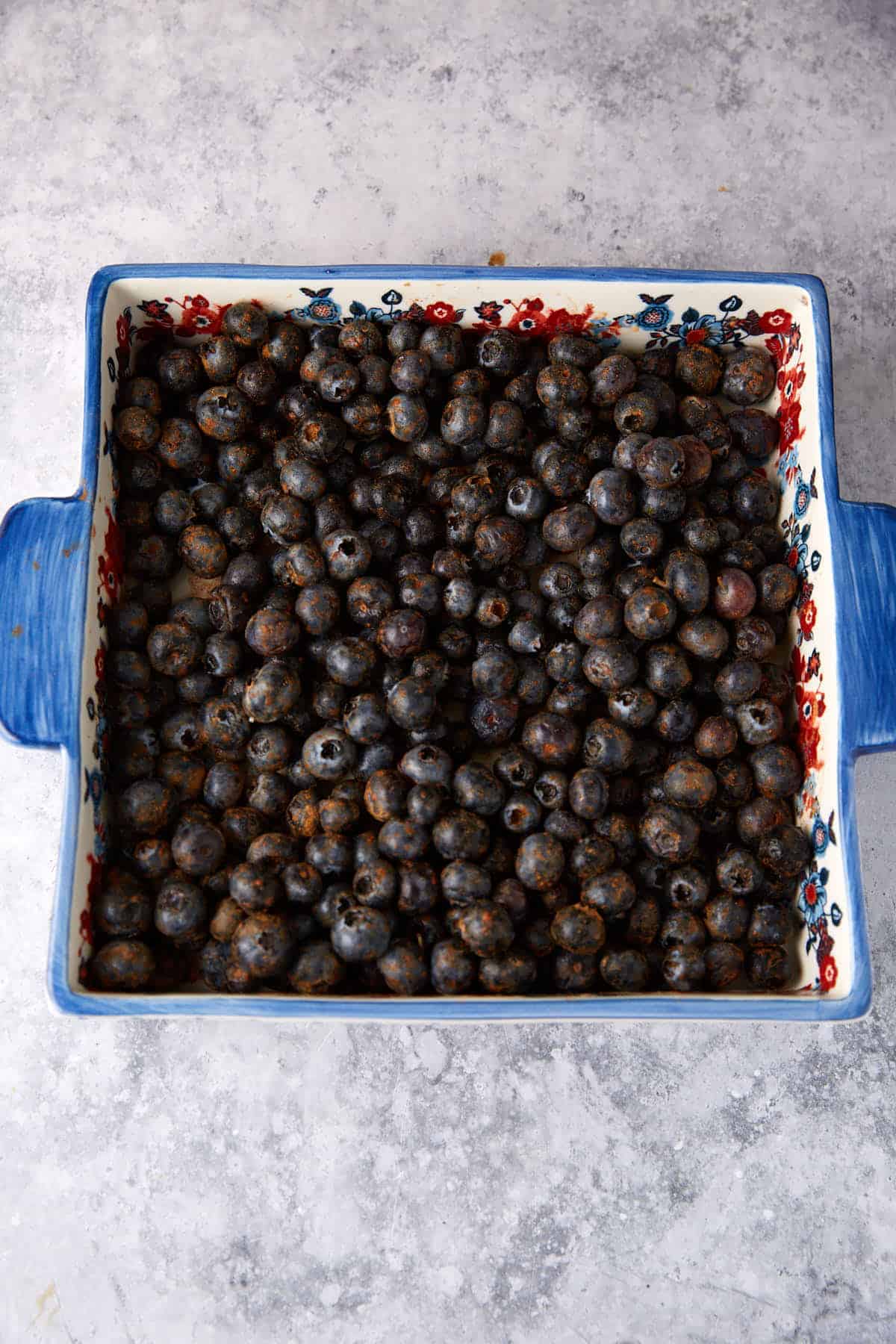 Seasoned blueberries in a casserole dish.