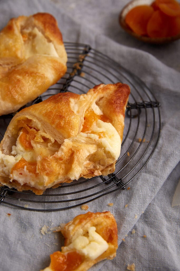 An apricot danish with a bite taken out.