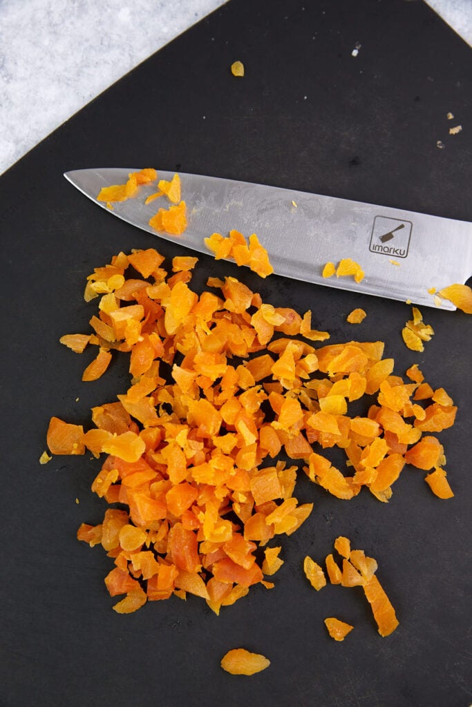Chopped apricots on a cutting board.