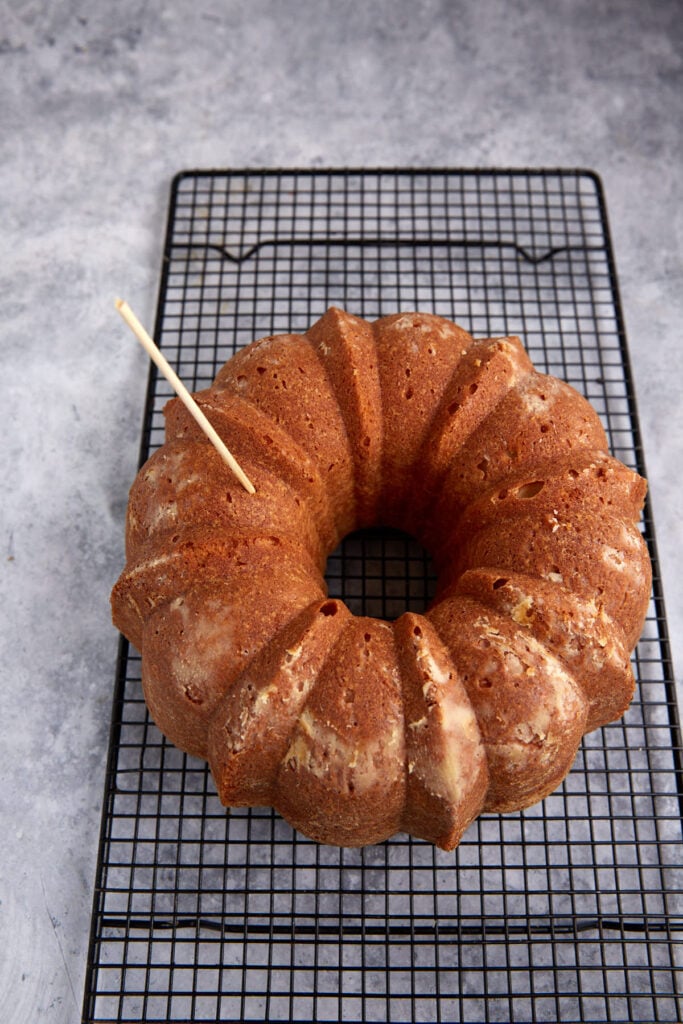 Holes being poked in a bundt cake.