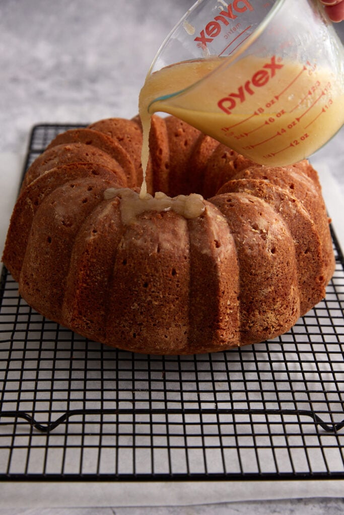 Butter glaze being poured over a cake.