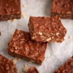 chocolate rice krispie squares on parchment paper.