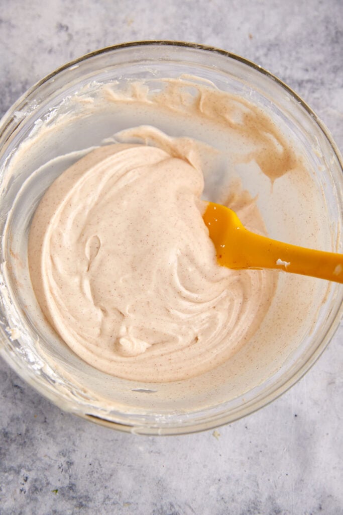 A bowl of cinnamon cream cheese frosting.