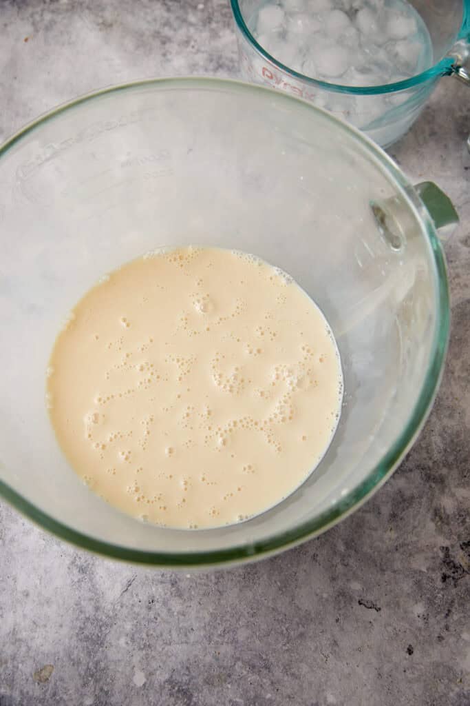 Water and sweetened condensed milk in a bowl.