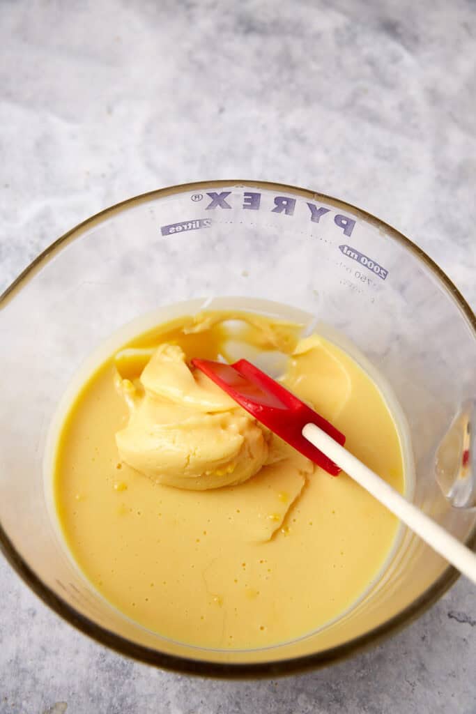 Thickened vanilla pudding in a bowl with a spatula.