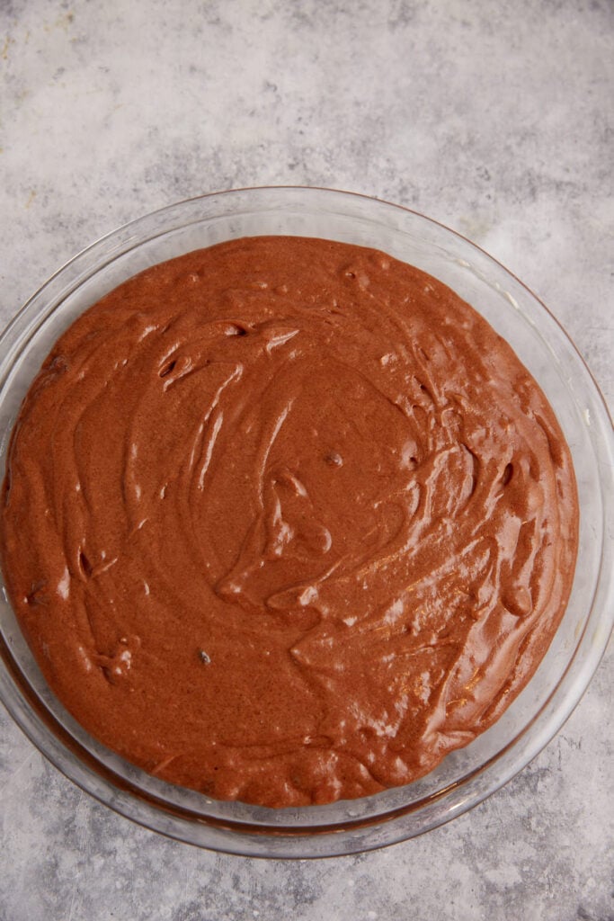 The batter for a brownie pie poured into a pie plate.