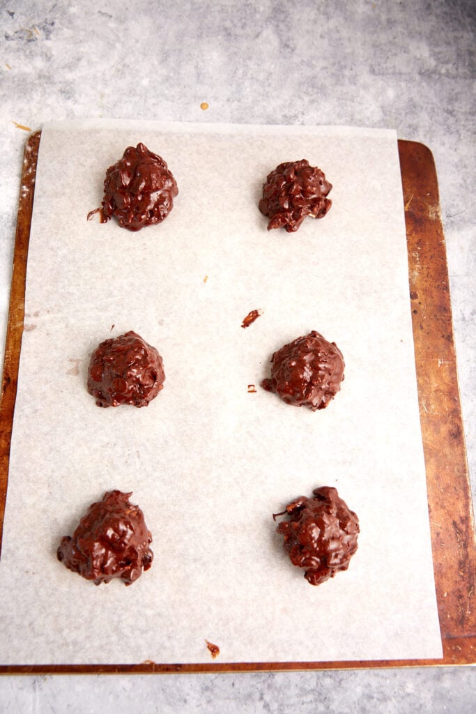 Cookie dough scooped onto a cookie sheet.
