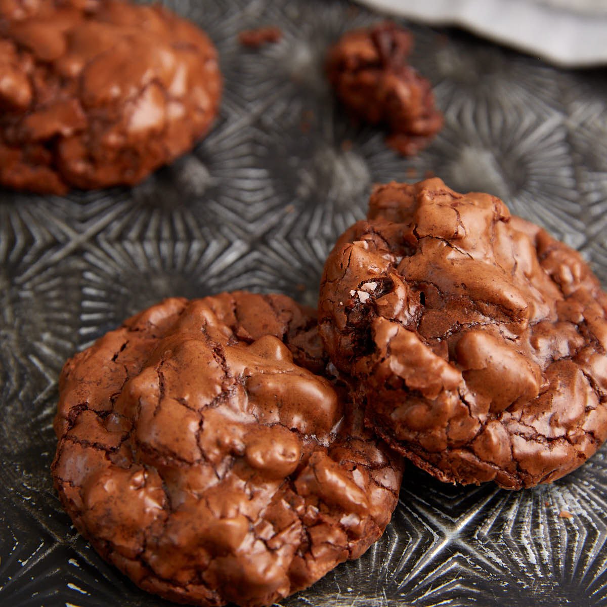Two chocolate cookies on a tray.