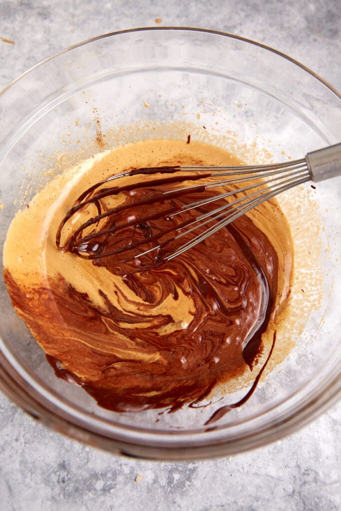 Chocolate being whisked into the cookie batter.