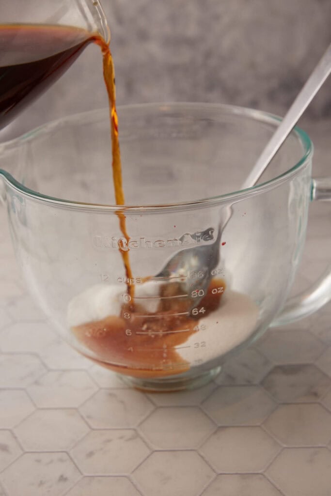 Hot tea being poured over sugar.