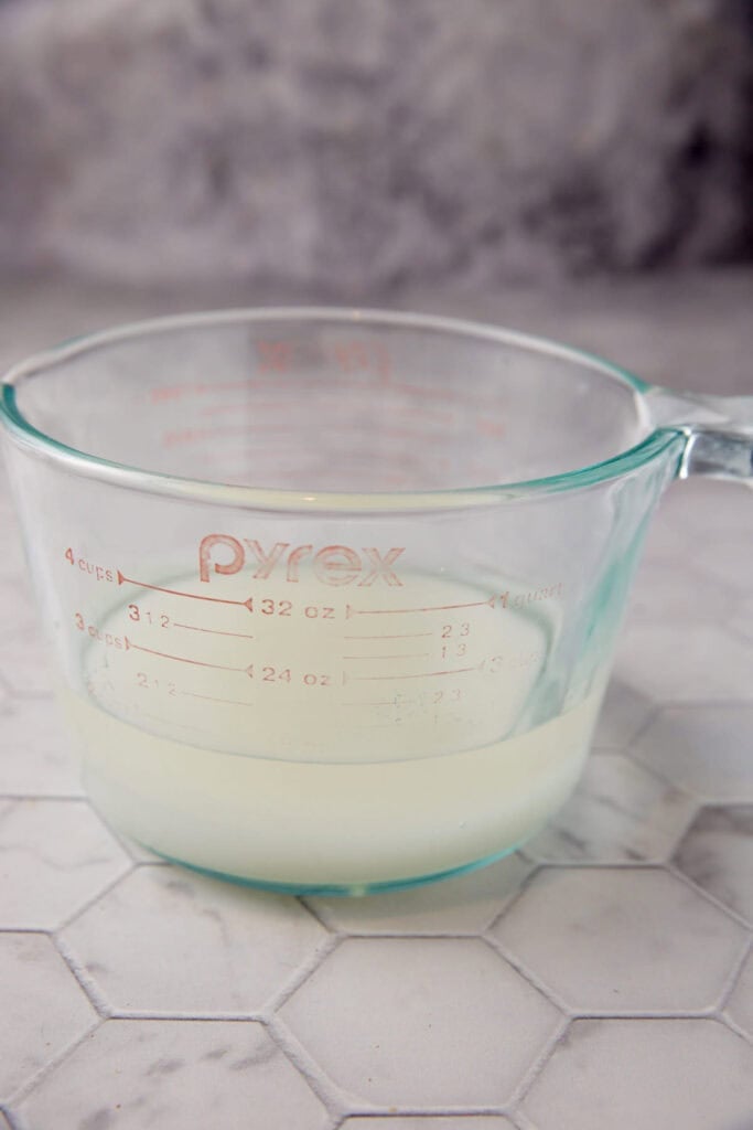 Water and sugar in a measuring cup.
