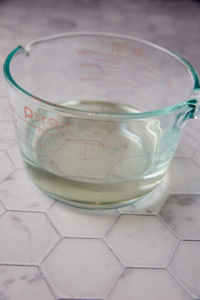 Sugar and water after it has dissolved in a measuring cup.