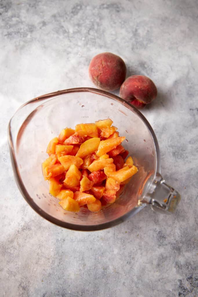 A bowl of cut peaches. 