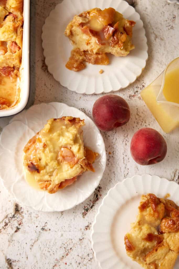 Three plates with bread pudding with peaches. 