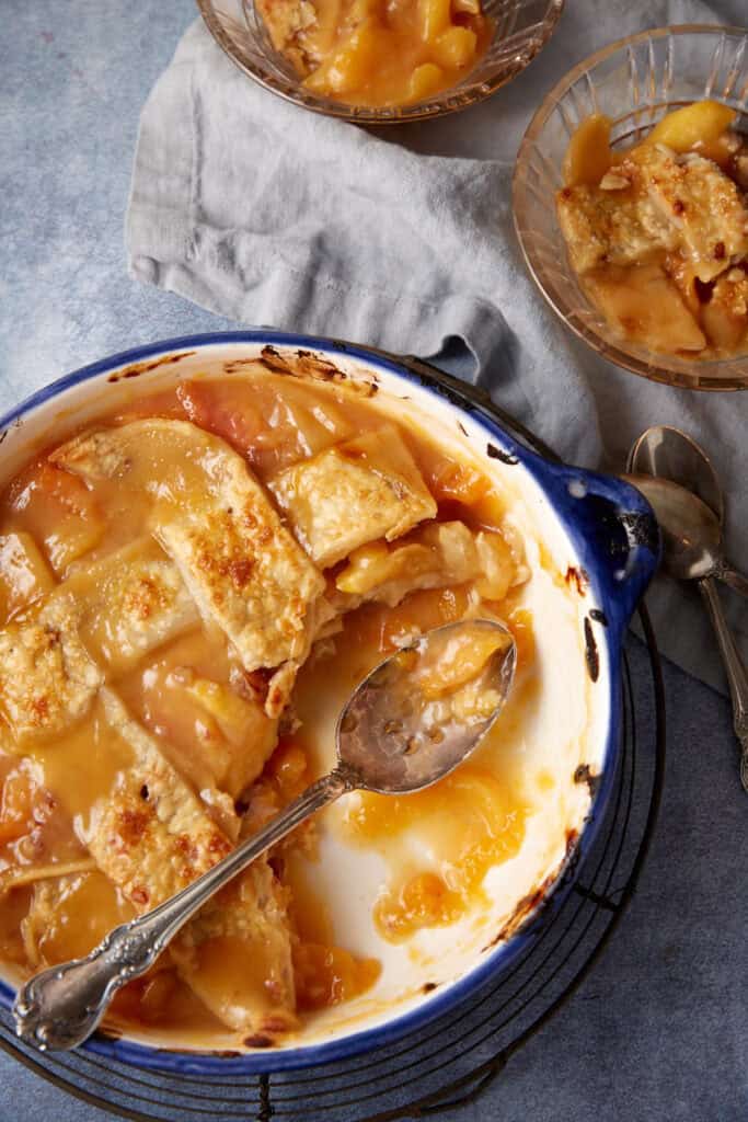 A half empty dish of peach cobbler.