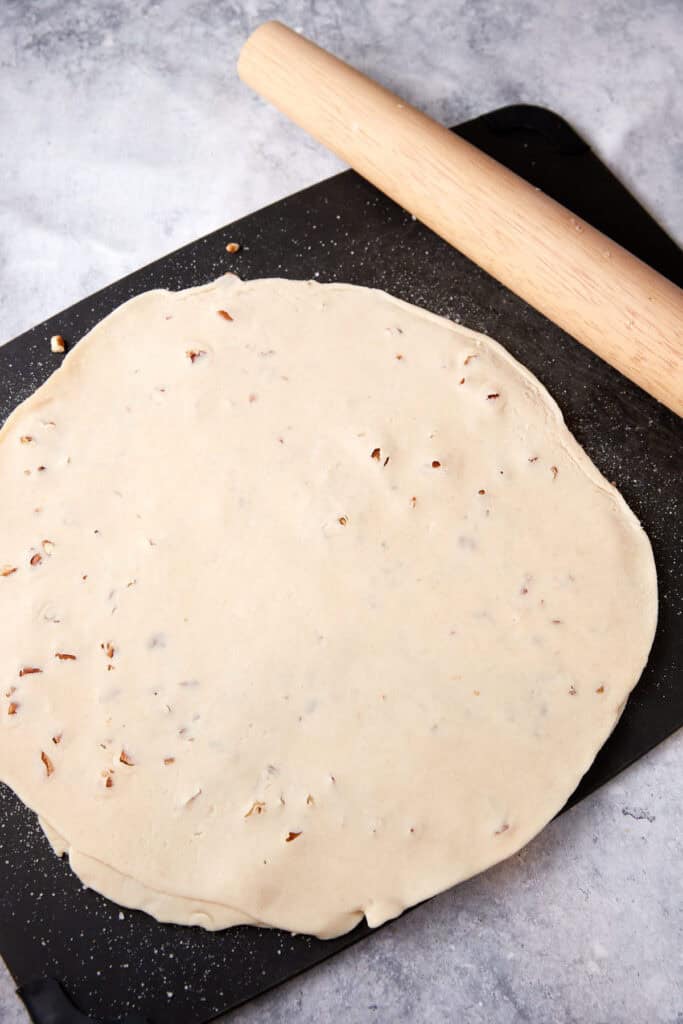 Two pie crusts with pecans in between.