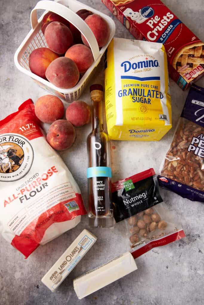 The ingredients for peach cobbler with pie crusts.