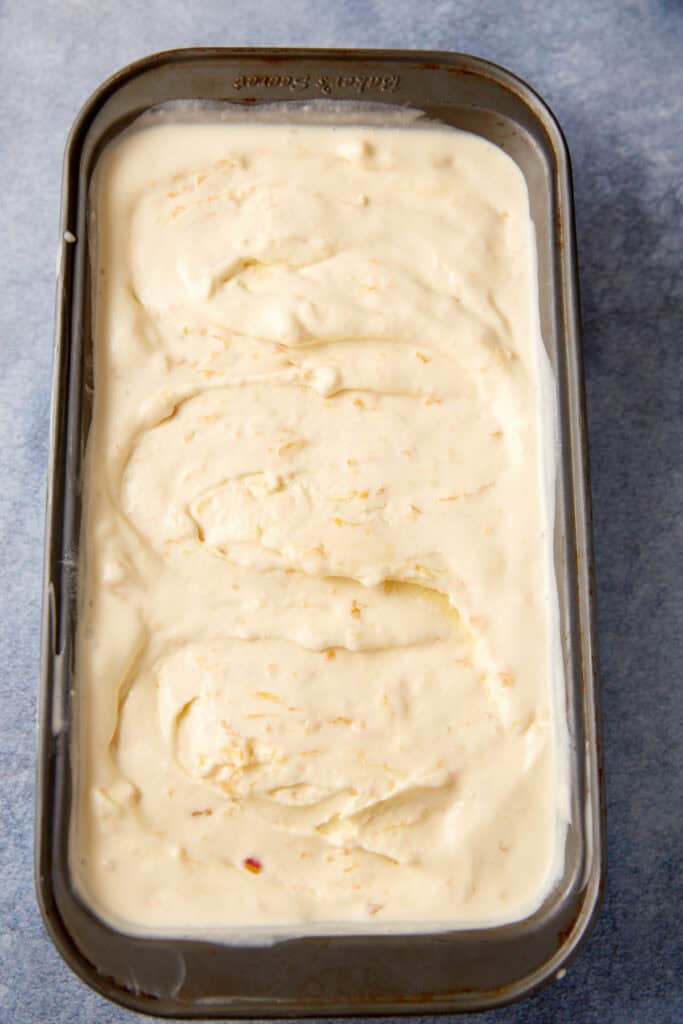 A loaf pan of peach ice cream.