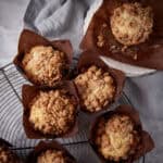 A batch of rhubarb muffins on a cooling rack.