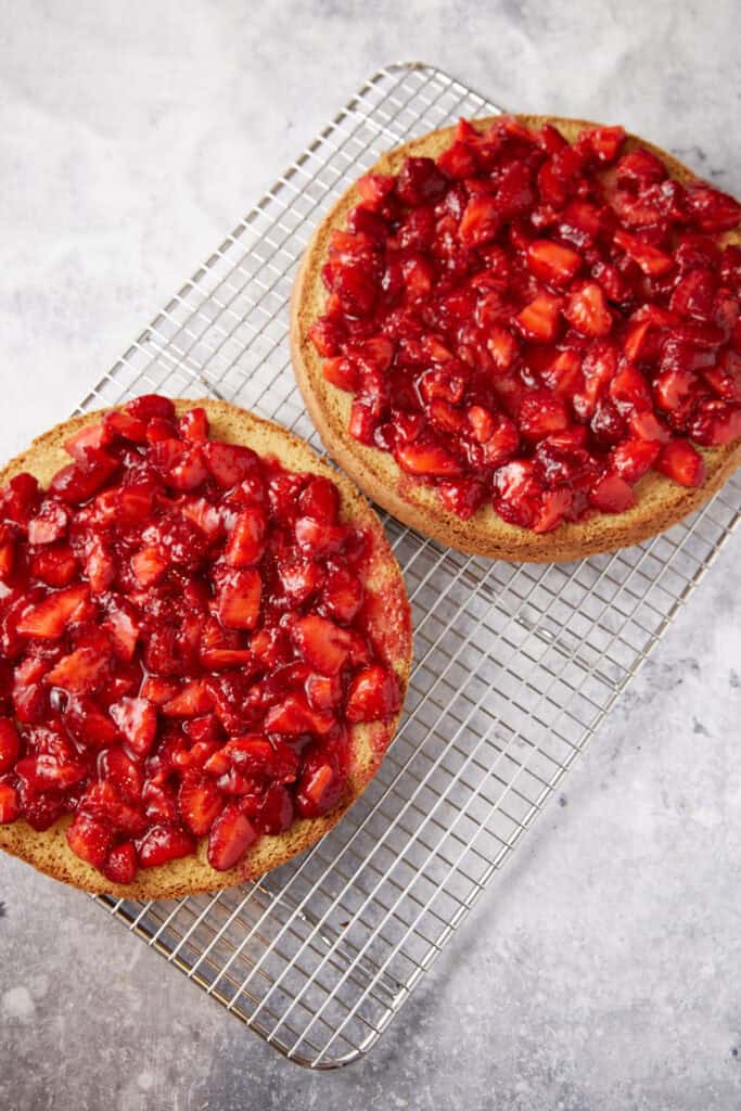 Cake layers covered with strawberries.