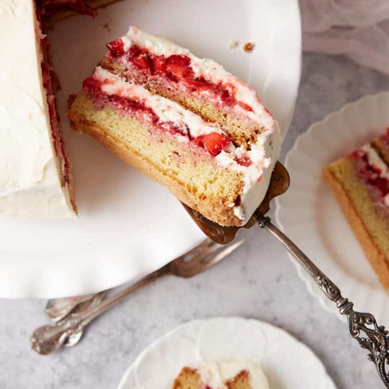 A slice of cake on a cake platter.