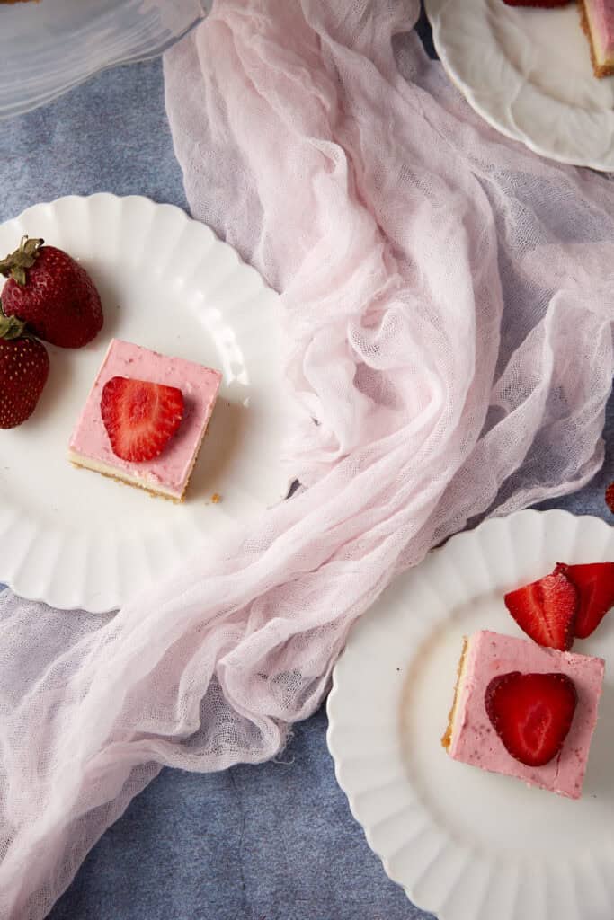 Two plates of strawberry bars.