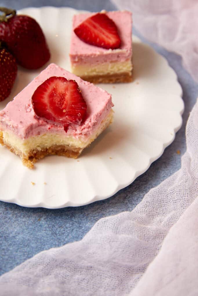 A cheesecake bar with a bite taken out.