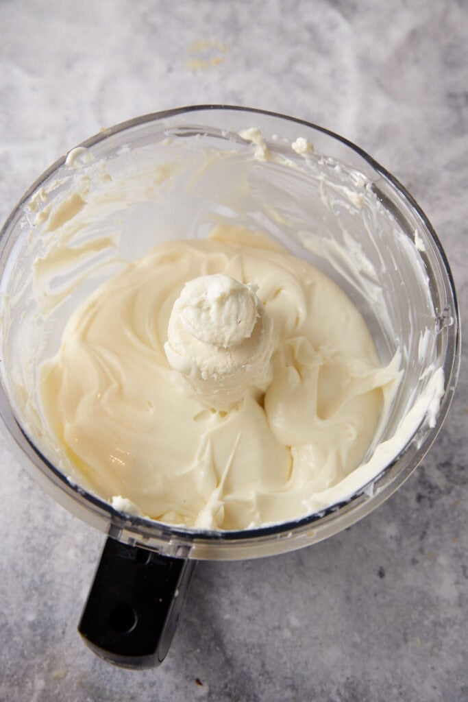 Cream cheese and sugar in a food processor.