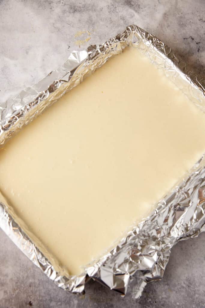 Cheesecake filling poured into a baking pan.