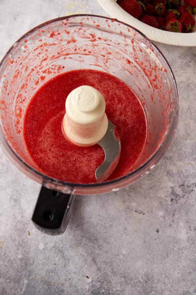 Strawberries pureed in a food processor.