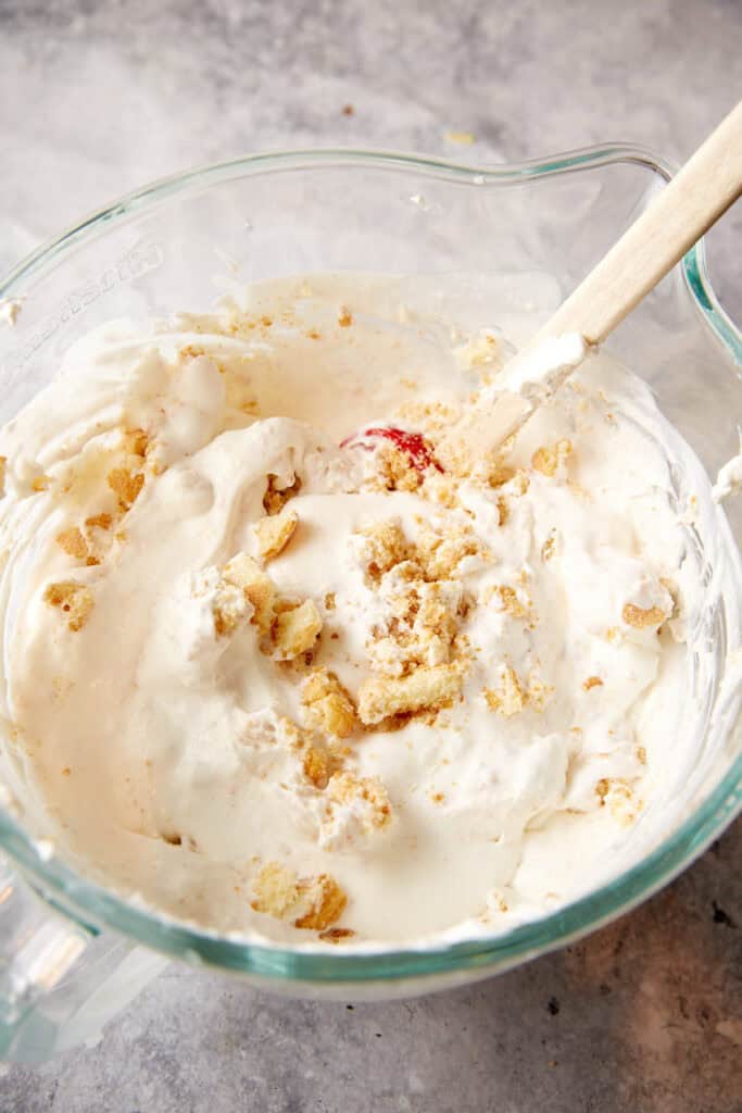 A bowl of cream with crumbled ladyfingers.